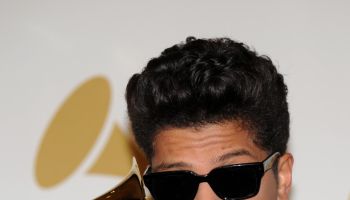 Bruno Mars poses with is award during th