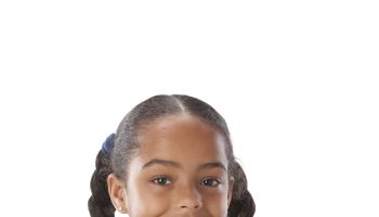 A head and shoulders image of a black little real girl with her arms crossed and a big smile on her face.