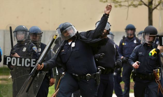 Cop Throws Rocks At Baltimore Protestors