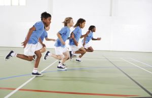 Children running in gymnasium