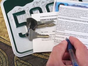 License Plate, Keys, and Papers Proving Evidence of Auto Insurance