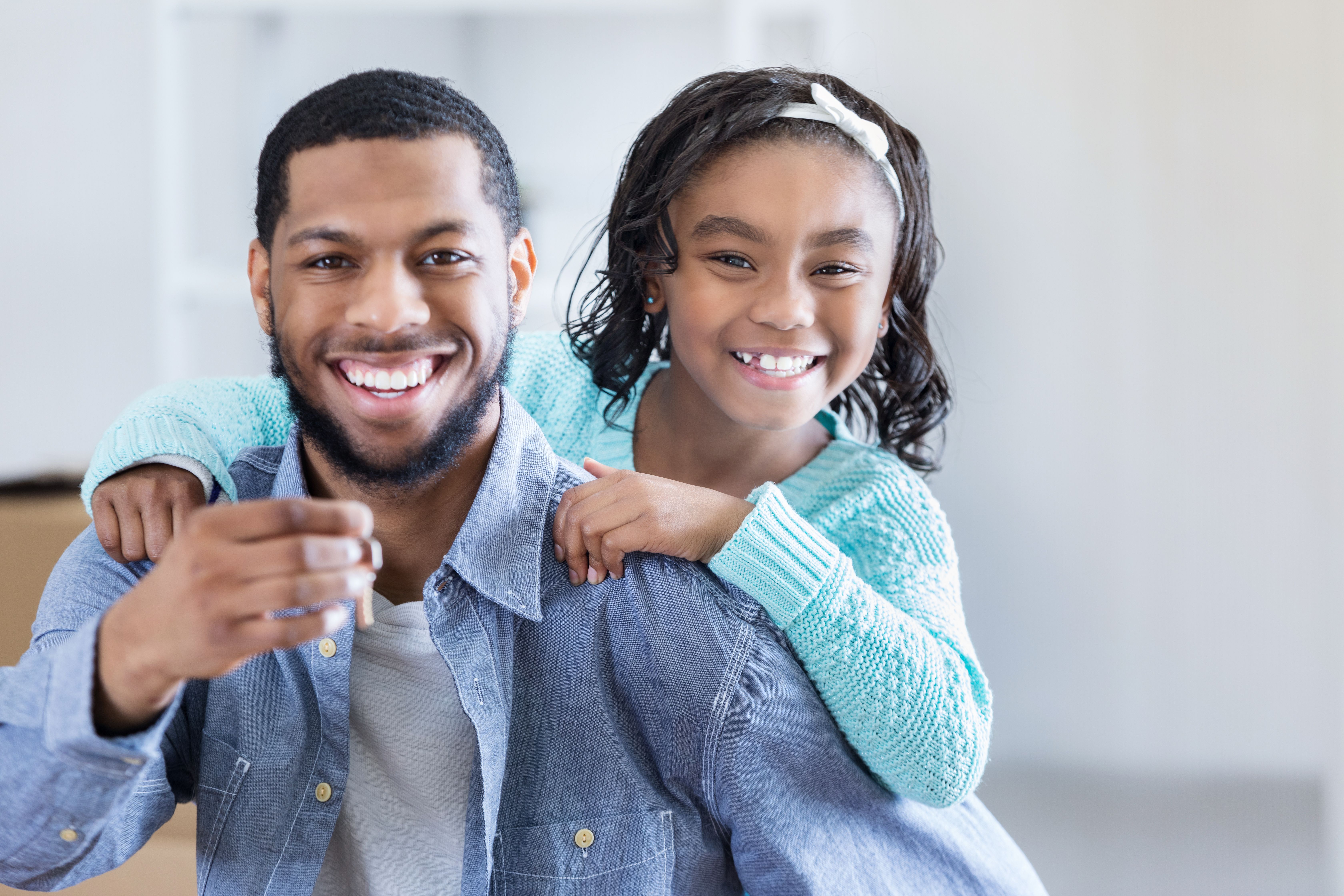 Excited father and daughter with new house keys
