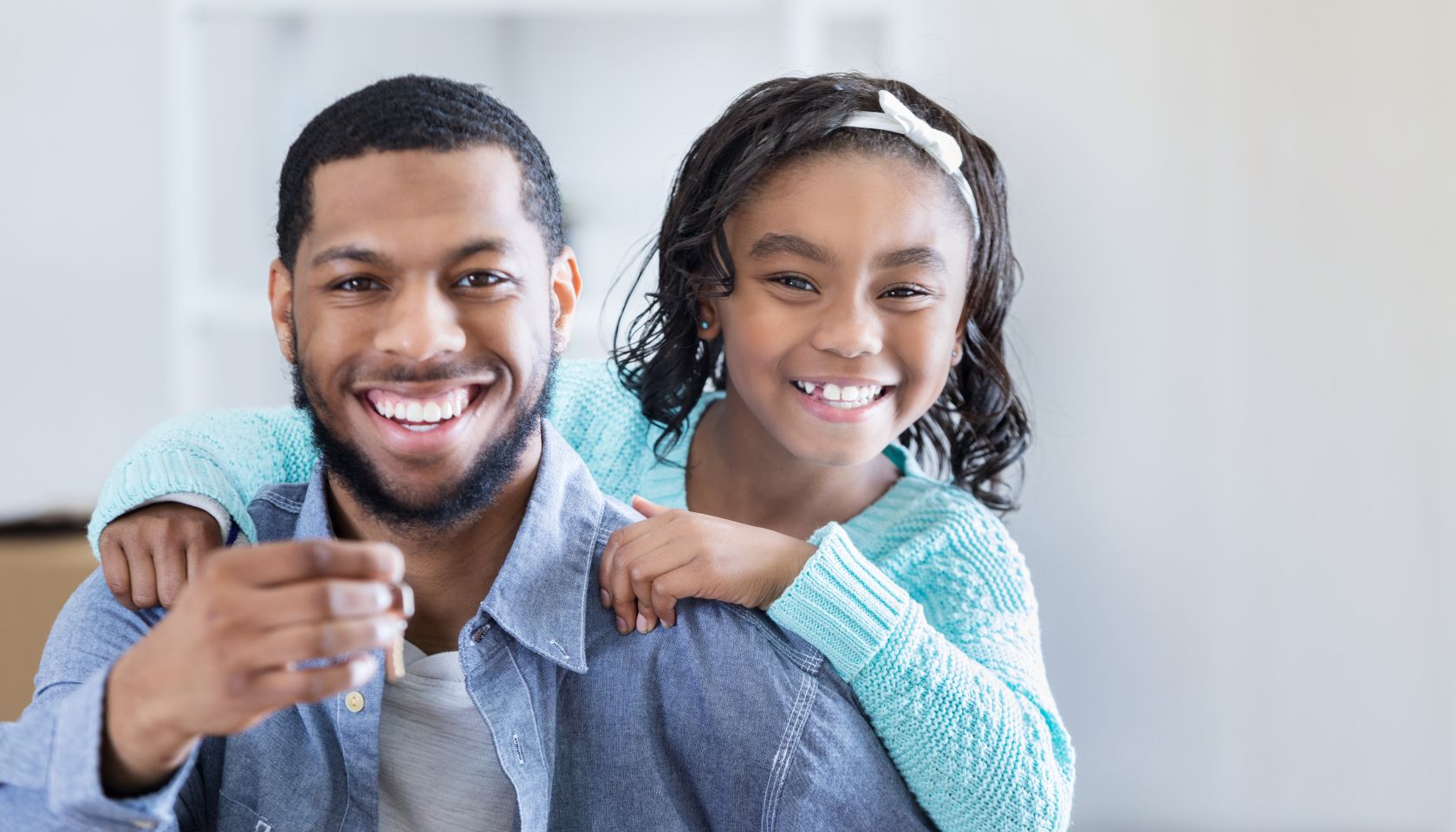Excited father and daughter with new house keys