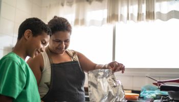 Afro latinx mother and son cooking at home