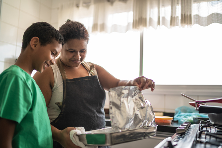 Afro latinx mother and son cooking at home