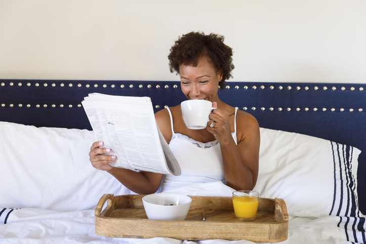 Woman having breakfast in bed