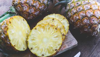 Close-Up Of Pineapples On Cutting Board