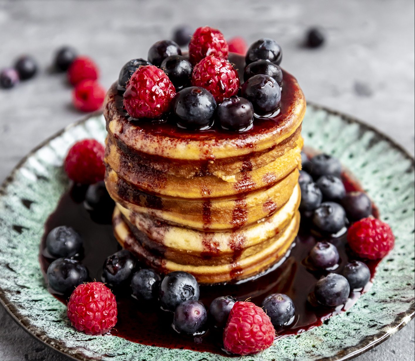 Pancakes with blueberries, raspberries and black currant sirup