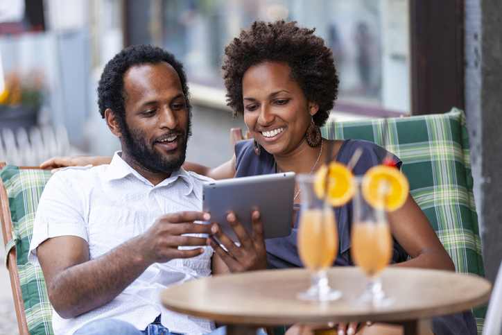 Black couple having fun with digital tablet