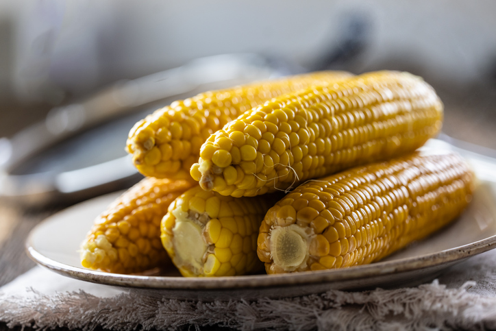Beautiful yellow boiled corn on a plate.
